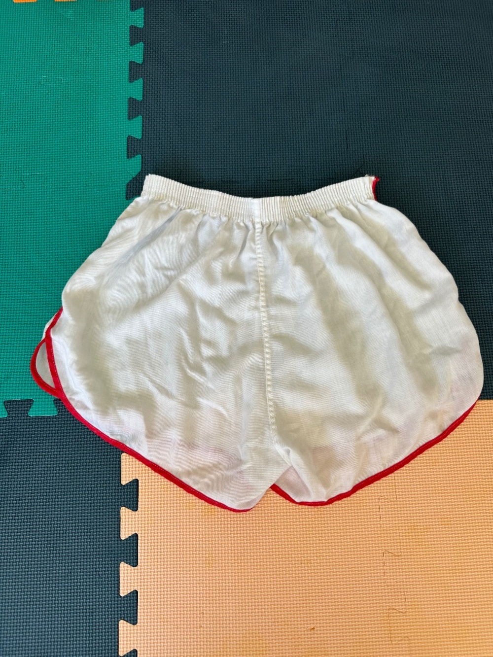 Vintage white athletic shorts with red trim